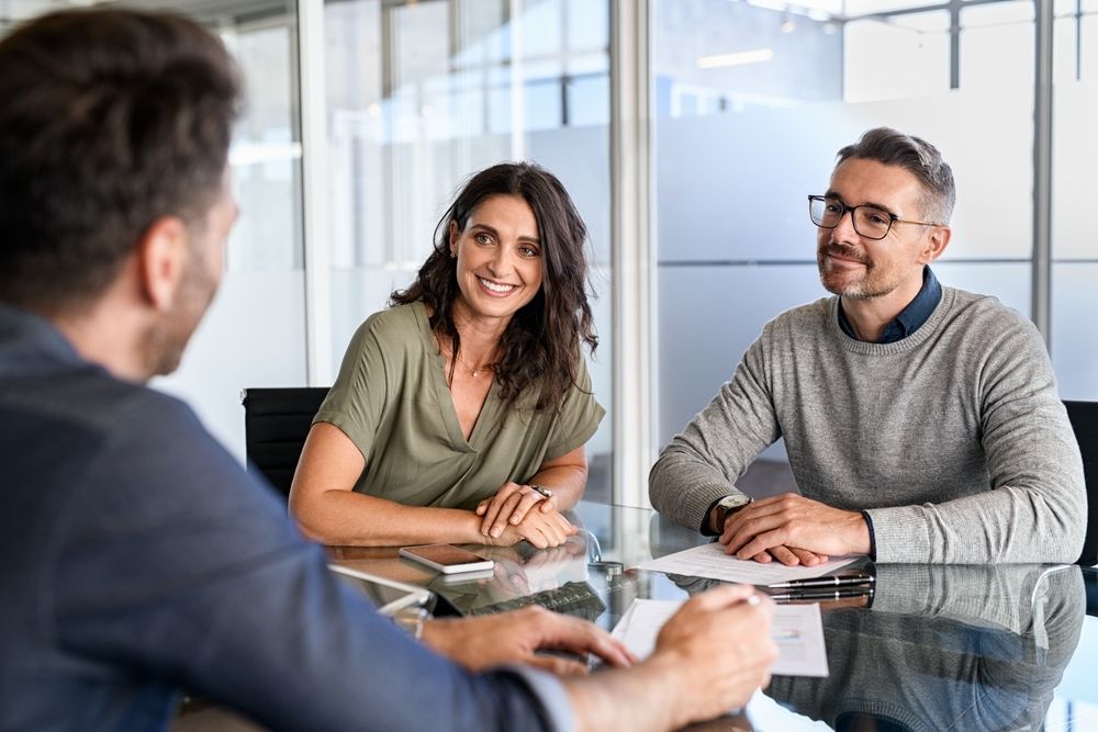 Couple Discussing Short Term Loan With Loan Agent