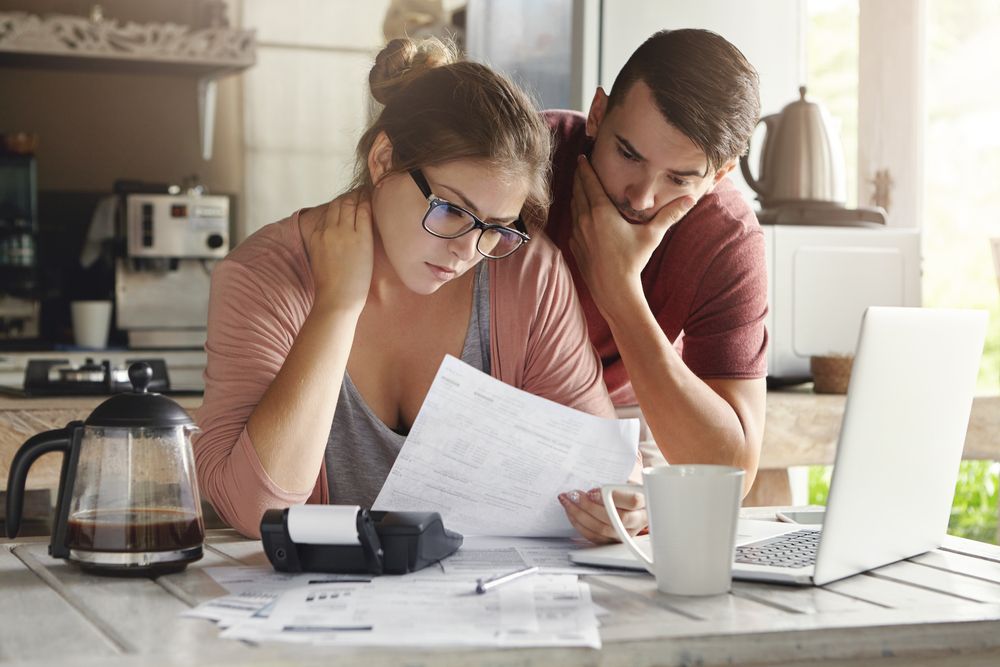 Couple Reading Terms Of Short Term Loan